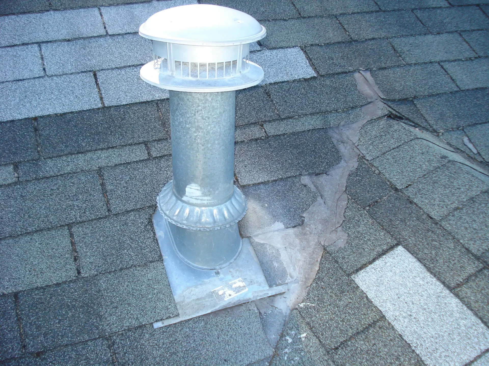 Leaking roof vent with failed tar patch before repair in Tacoma, WA