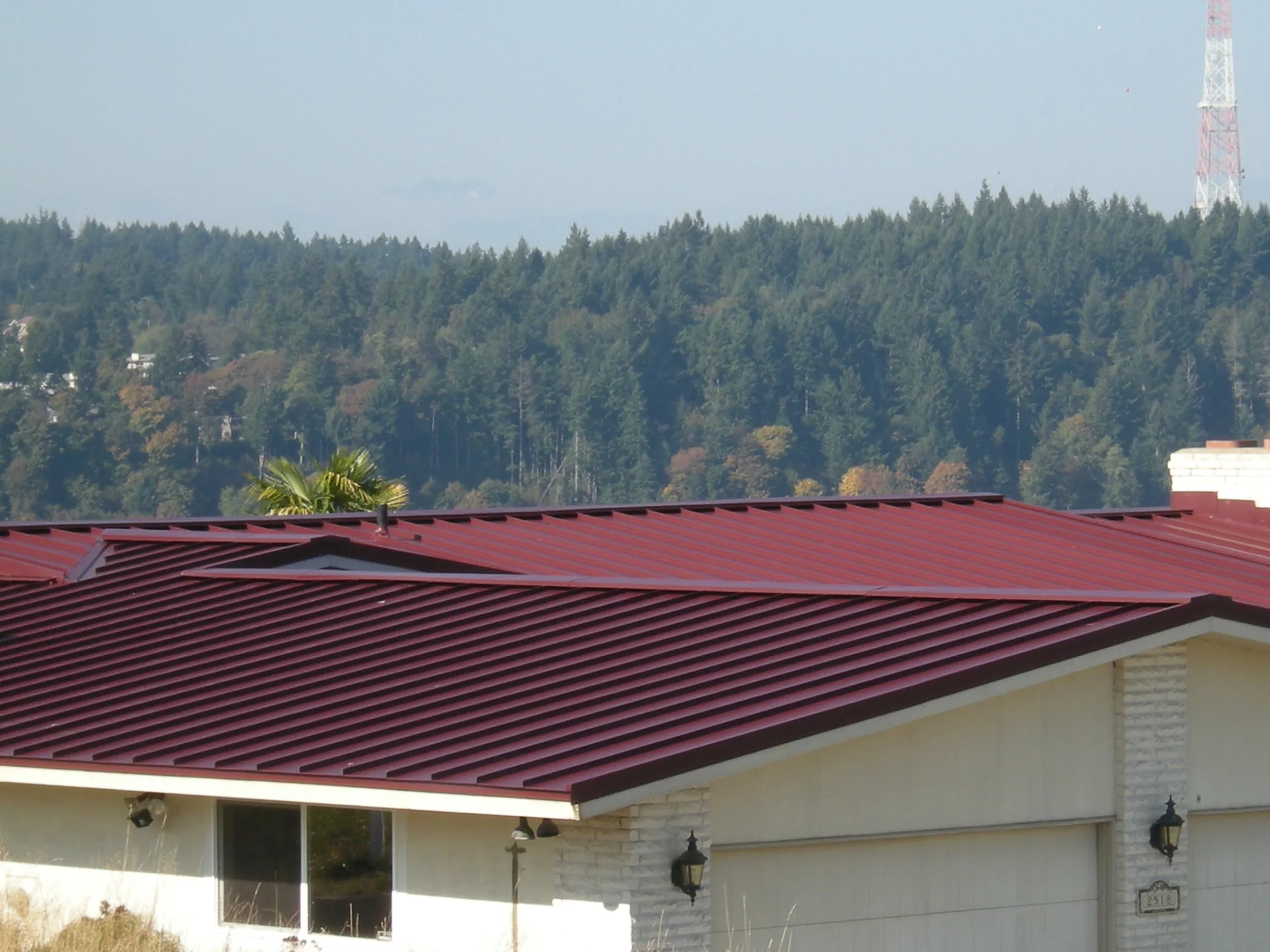 Close-up of a new red standing seam metal roof installed in Tacoma, WA