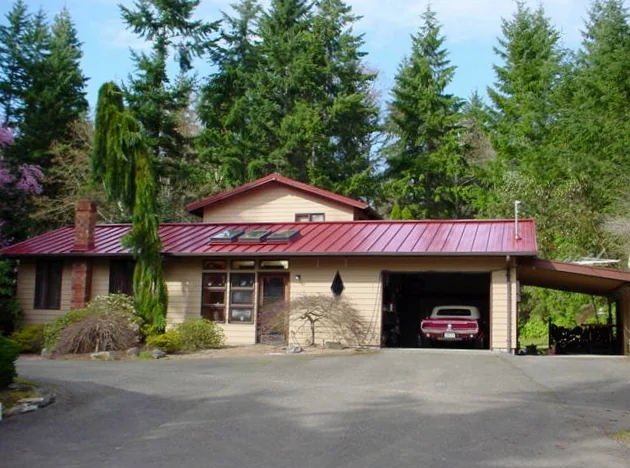 Colonial red standing seam metal roof with skylights in Pierce County