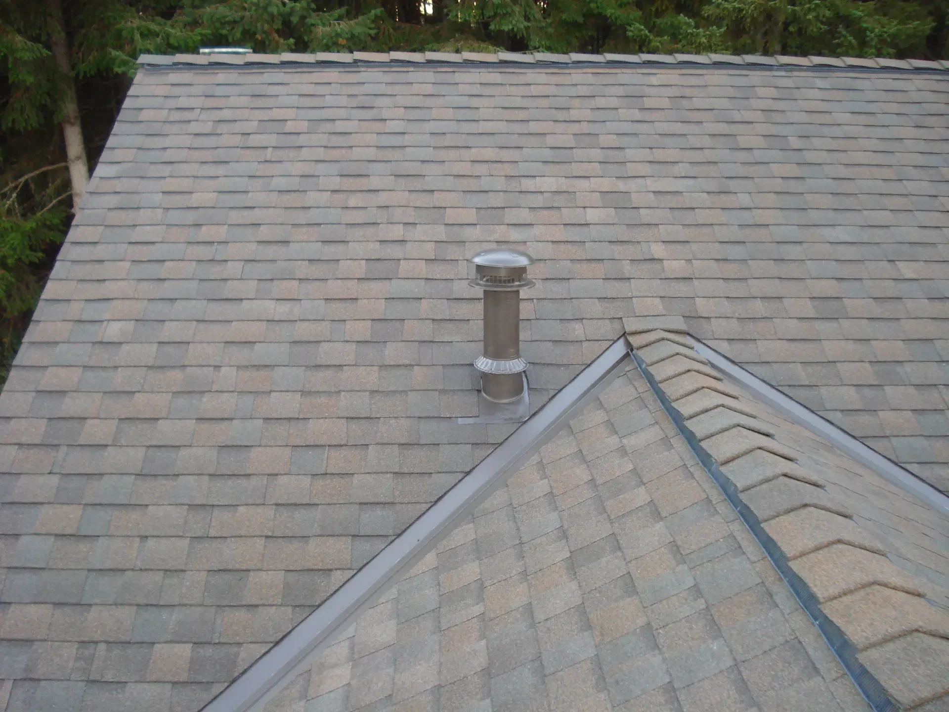 Properly flashed roof vent on a new shingle roof after repair by DHT Construction & Roofing