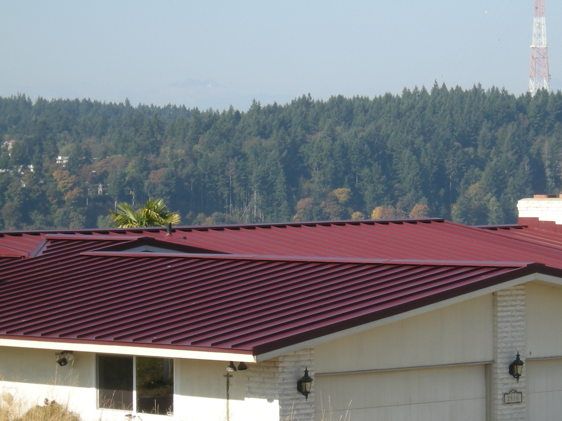 Close-up of a new red standing seam metal roof installed in Tacoma, WA