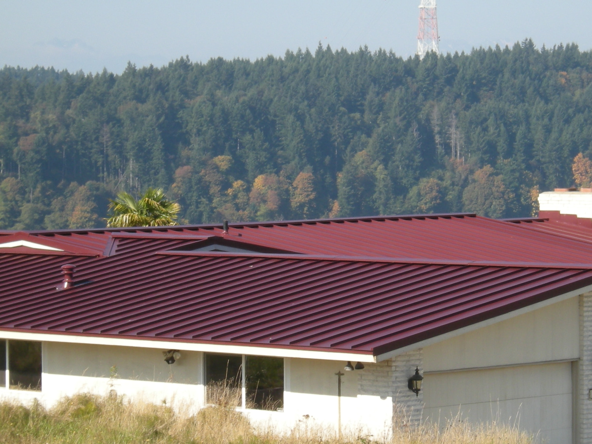 Wide view of a completed maroon metal roof install in Tacoma, WA