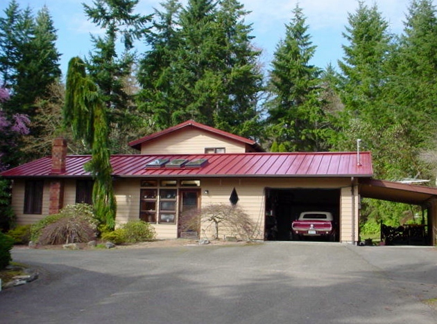 Colonial red standing seam metal roof with skylights in Pierce County