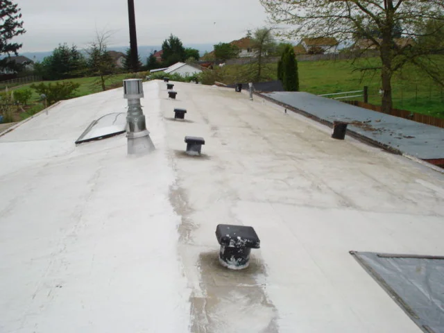 Worn low-slope roof before standing seam metal roofing in Tacoma, WA