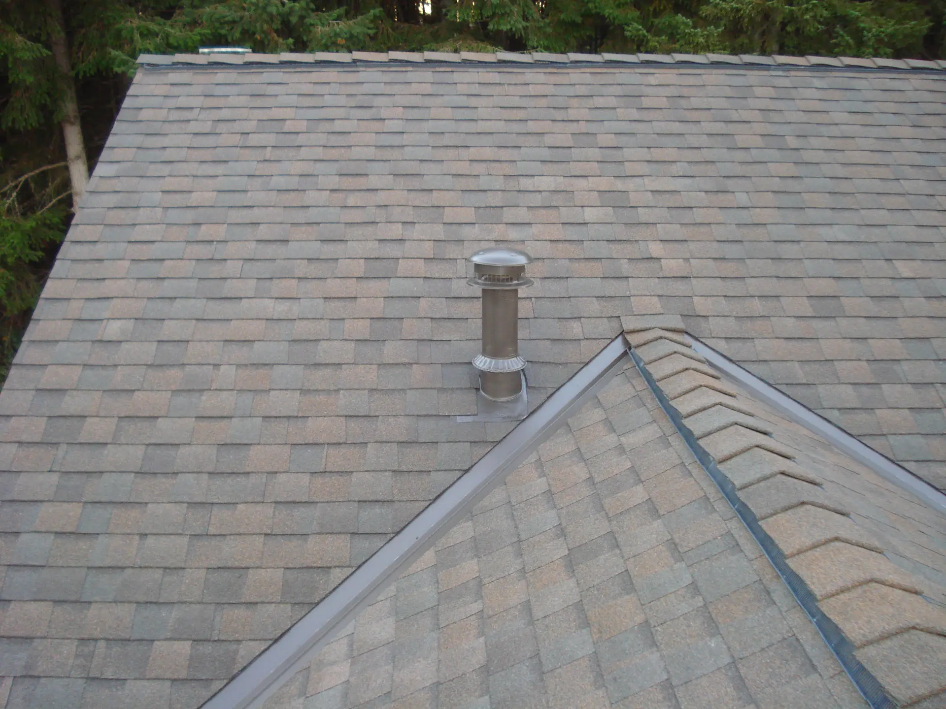 Properly flashed roof vent on a new shingle roof after repair by DHT Construction & Roofing