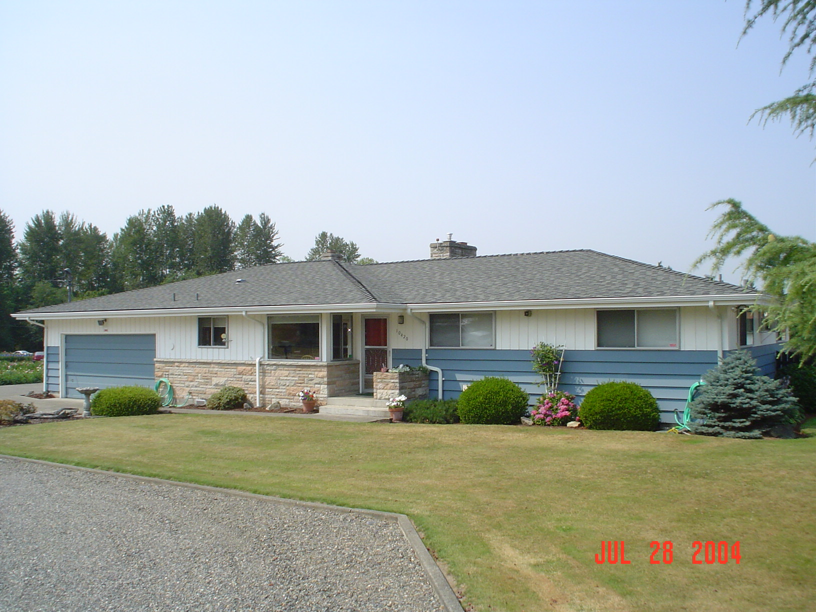 Ranch home after its completed gray asphalt shingle roof replacement